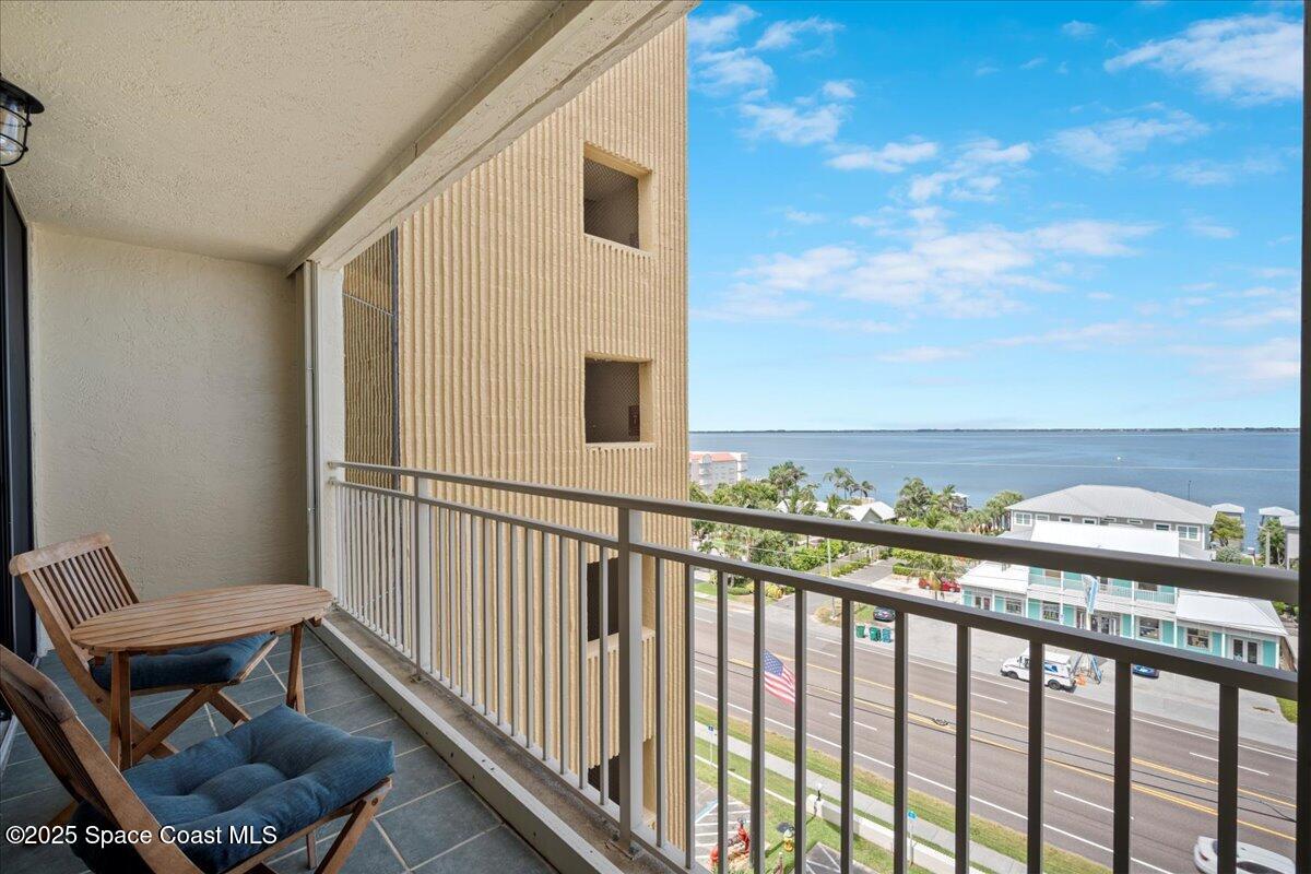3221 South Atlantic Avenue, Unit 703 Cocoa Beach, FL 32931 - Photo 41 of 77 a view of a balcony with chair and wooden floor