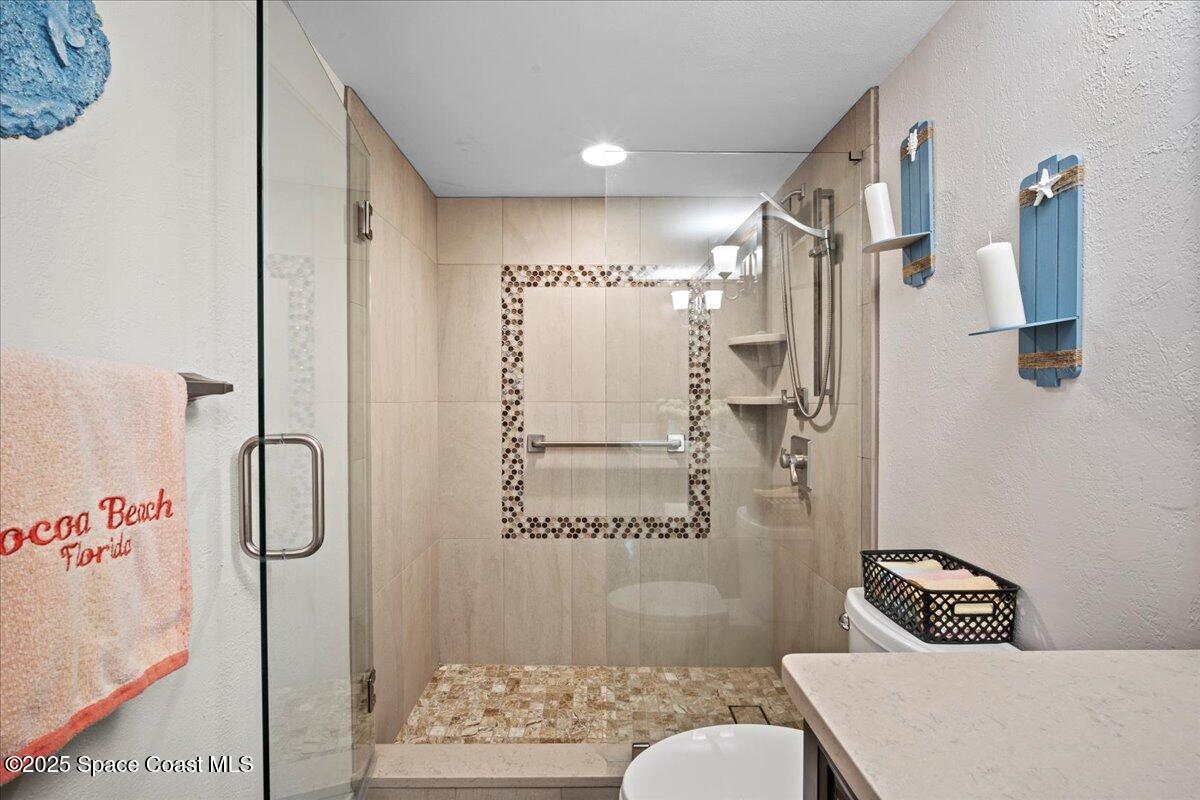 3221 South Atlantic Avenue, Unit 703 Cocoa Beach, FL 32931 - Photo 44 of 77 a bathroom with a shower and a sink