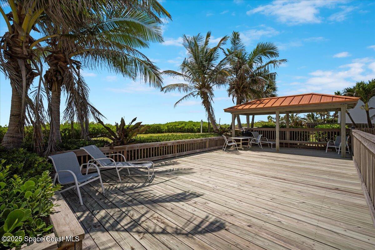 3221 South Atlantic Avenue, Unit 703 Cocoa Beach, FL 32931 - Photo 59 of 77 a swimming pool with outdoor seating yard and barbeque oven