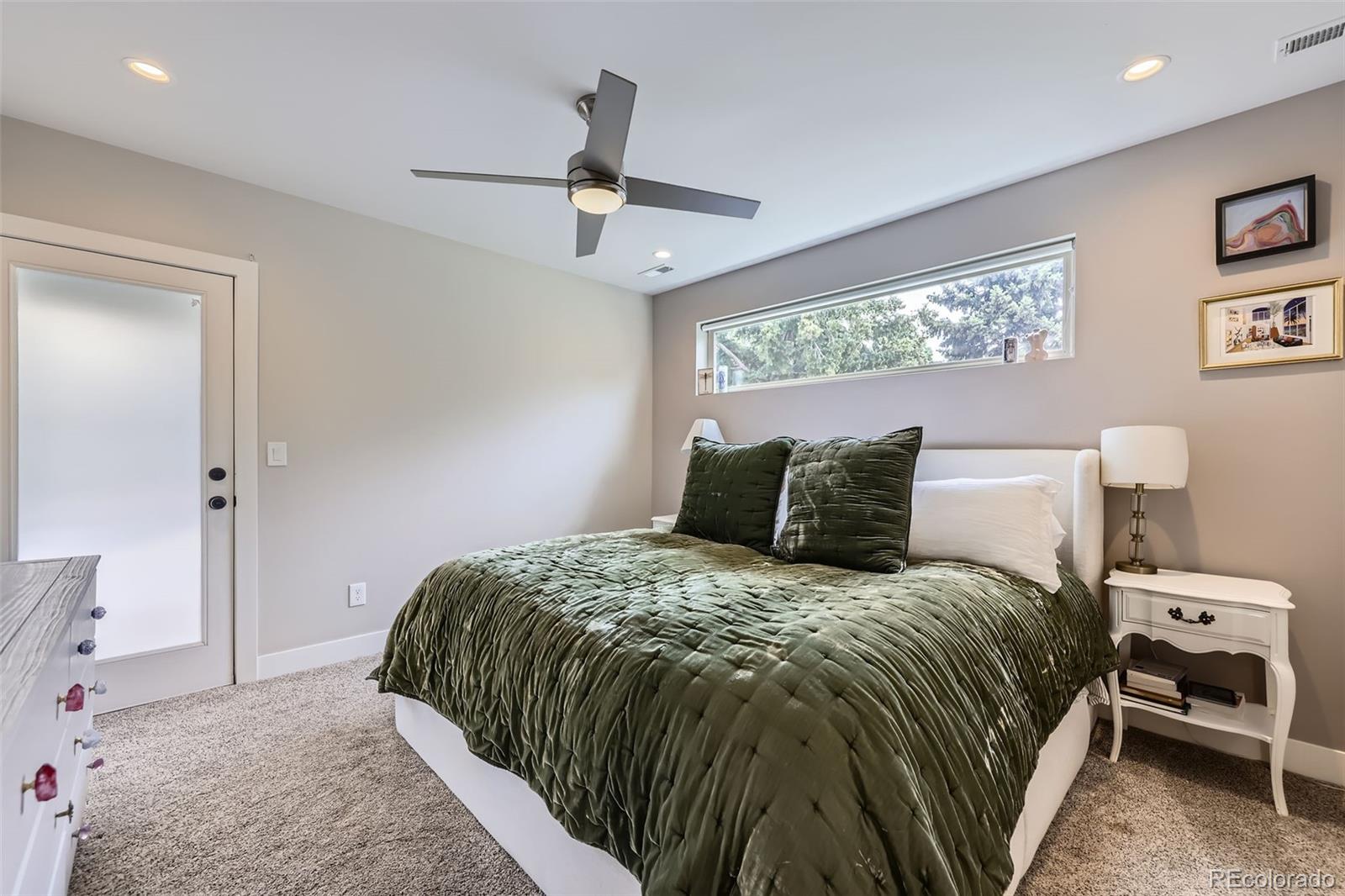 4455 Tejon Street Denver, CO 80211 - Photo 13 of 28 a bedroom with a bed and painting on the wall