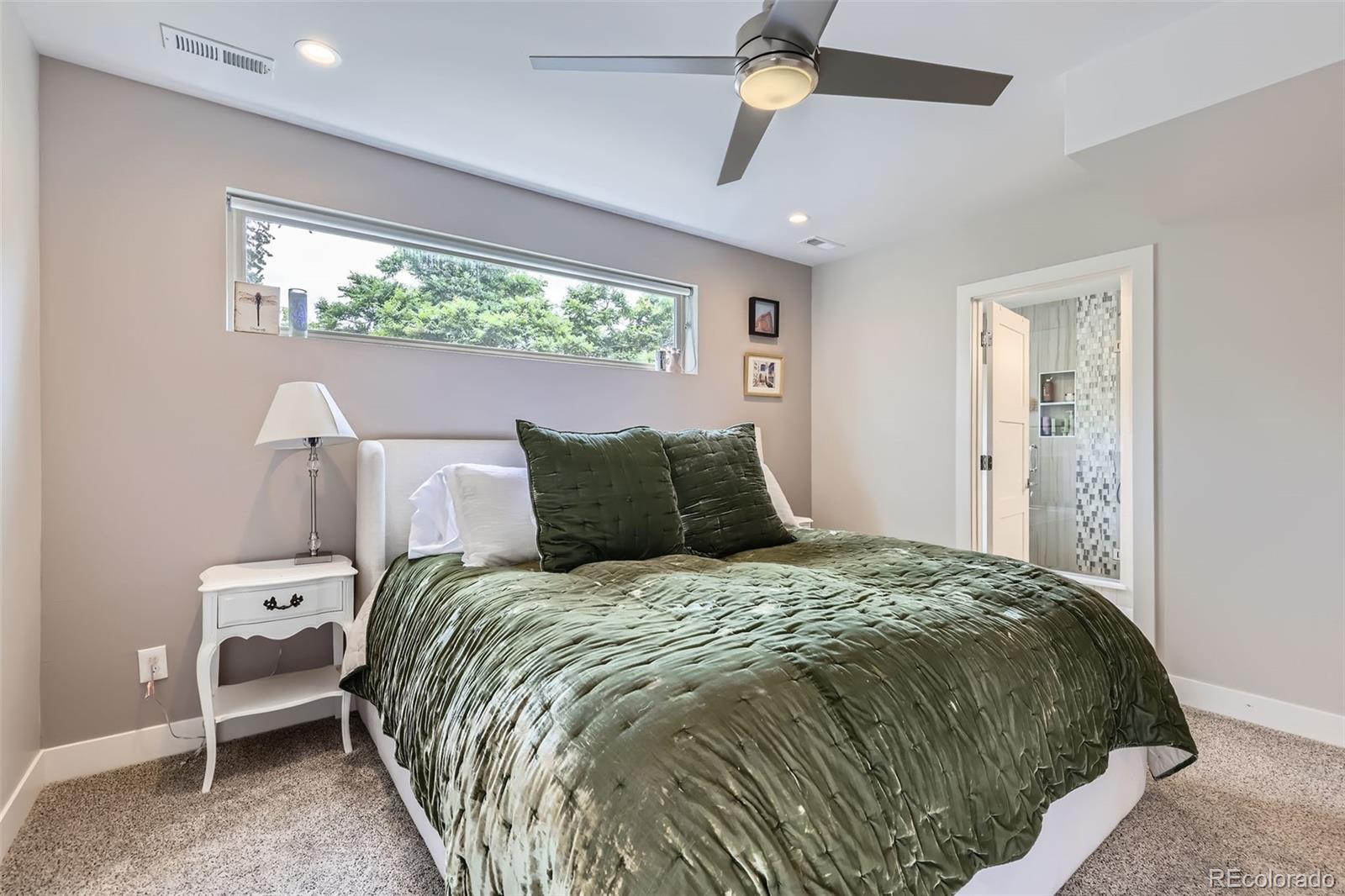 4455 Tejon Street Denver, CO 80211 - Photo 14 of 28 a large bed sitting in a bedroom next to a window