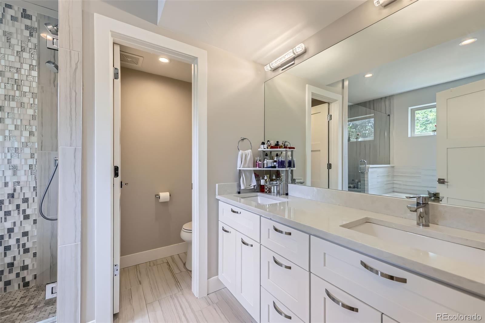 4455 Tejon Street Denver, CO 80211 - Photo 15 of 28 a spacious bathroom with a double vanity sink and mirror