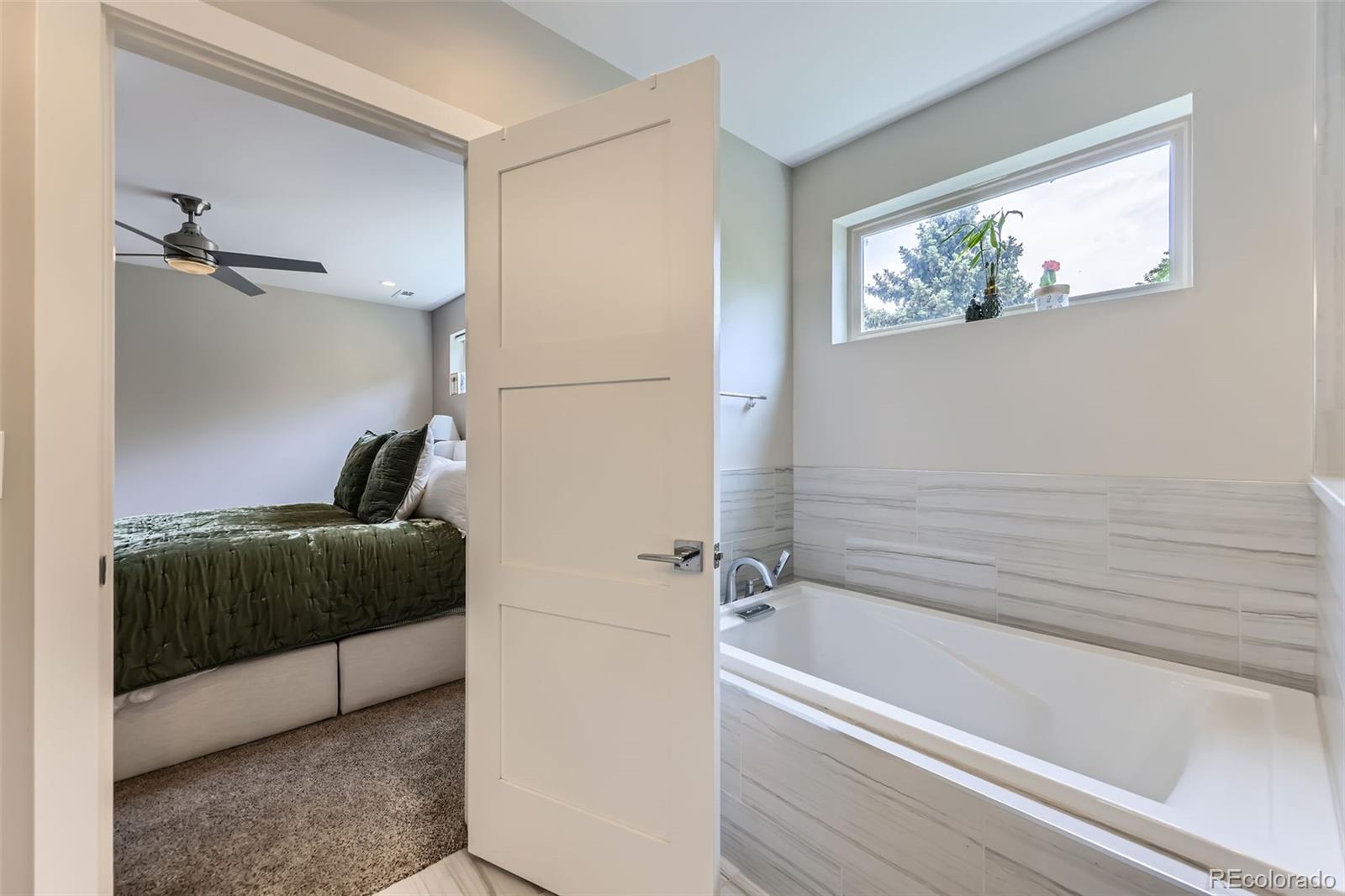 4455 Tejon Street Denver, CO 80211 - Photo 16 of 28 a bathroom with a tub and a shower