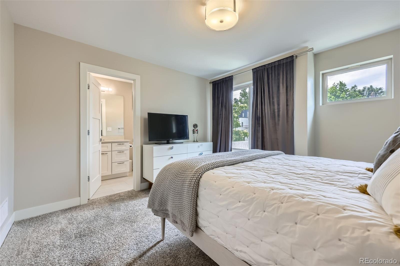 4455 Tejon Street Denver, CO 80211 - Photo 19 of 28 a bedroom with a bed and a television