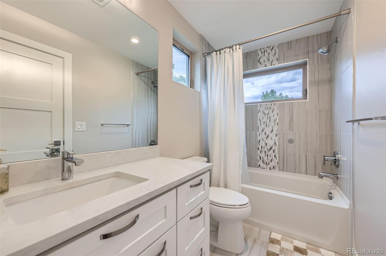 4455 Tejon Street Denver, CO 80211 - Photo 20 of 28 a bathroom with a sink a toilet and a bathtub