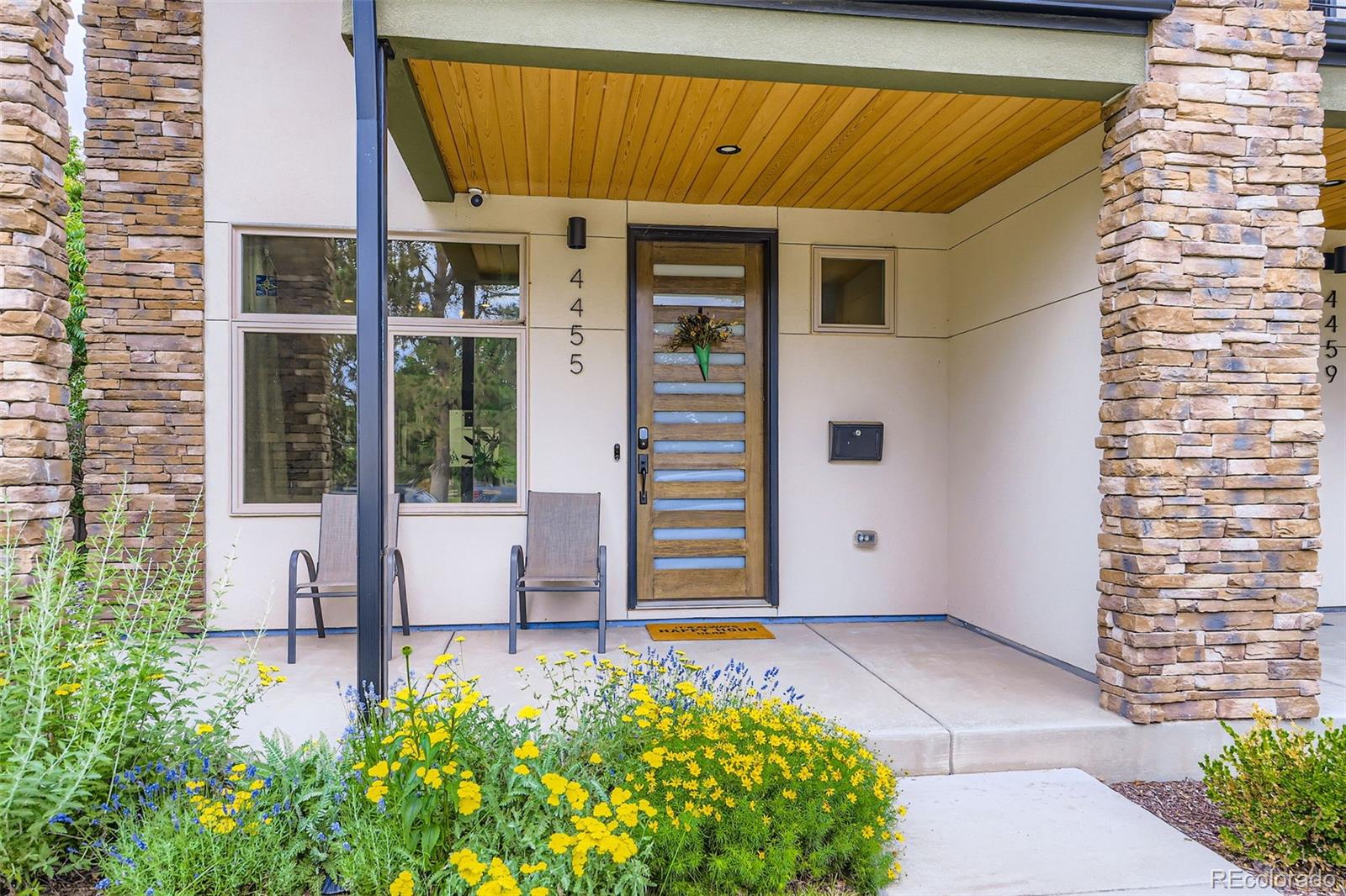 4455 Tejon Street Denver, CO 80211 - Photo 3 of 28 a front view of a house with a yard
