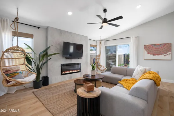a living room with fireplace furniture and a flat screen tv