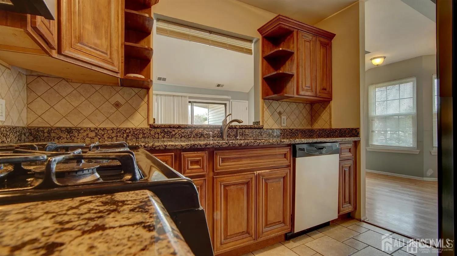 3003 Lighthouse Lane Parlin, NJ 08859 - Photo 11 of 25 a close view of a sink and a stove in the kitchen