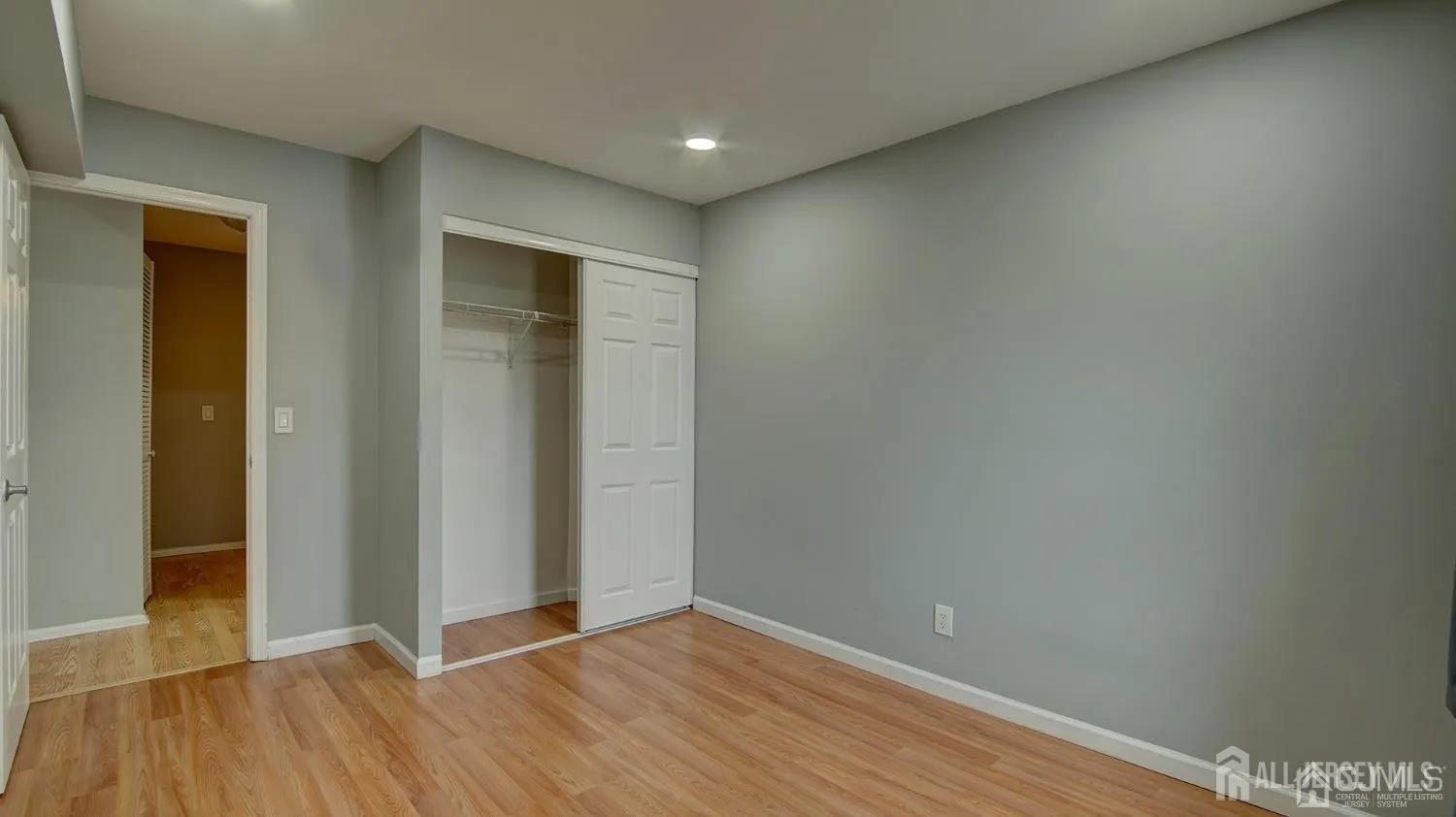 3003 Lighthouse Lane Parlin, NJ 08859 - Photo 16 of 25 an empty room with wooden floor and closet