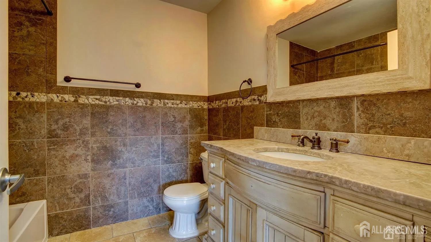 3003 Lighthouse Lane Parlin, NJ 08859 - Photo 19 of 25 a bathroom with a sink and a toilet