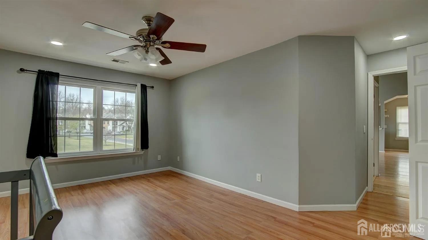 3003 Lighthouse Lane Parlin, NJ 08859 - Photo 21 of 25 a view of an empty room with wooden floor and a window