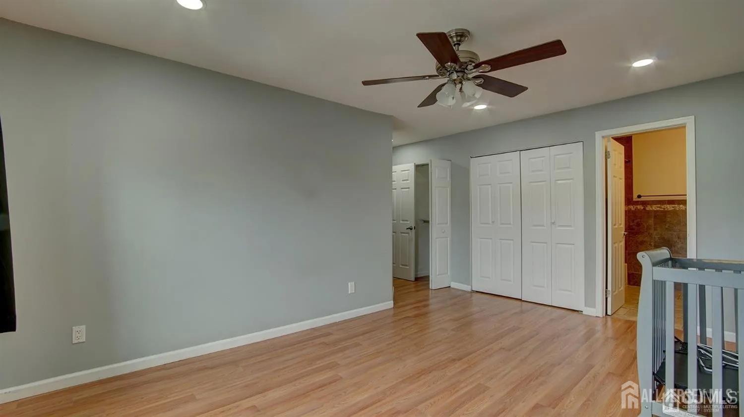 3003 Lighthouse Lane Parlin, NJ 08859 - Photo 22 of 25 a view of an empty room with wooden floor and a window