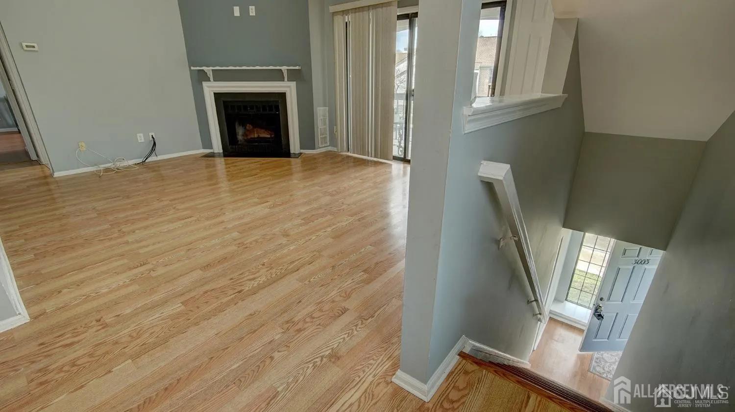3003 Lighthouse Lane Parlin, NJ 08859 - Photo 4 of 25 a view of an empty room with wooden floor and a window