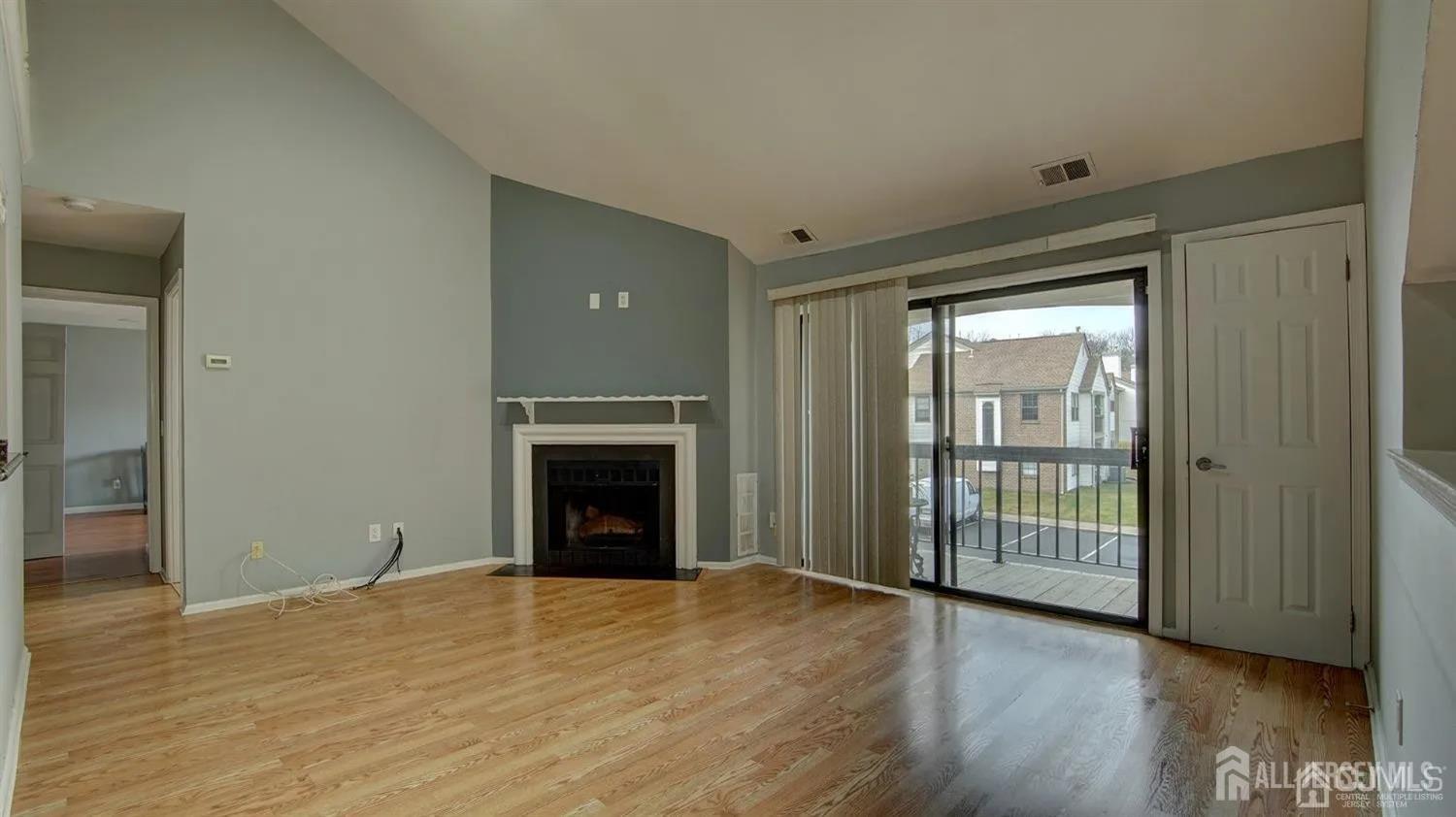 3003 Lighthouse Lane Parlin, NJ 08859 - Photo 5 of 25 a view of empty room with wooden floor and fireplace