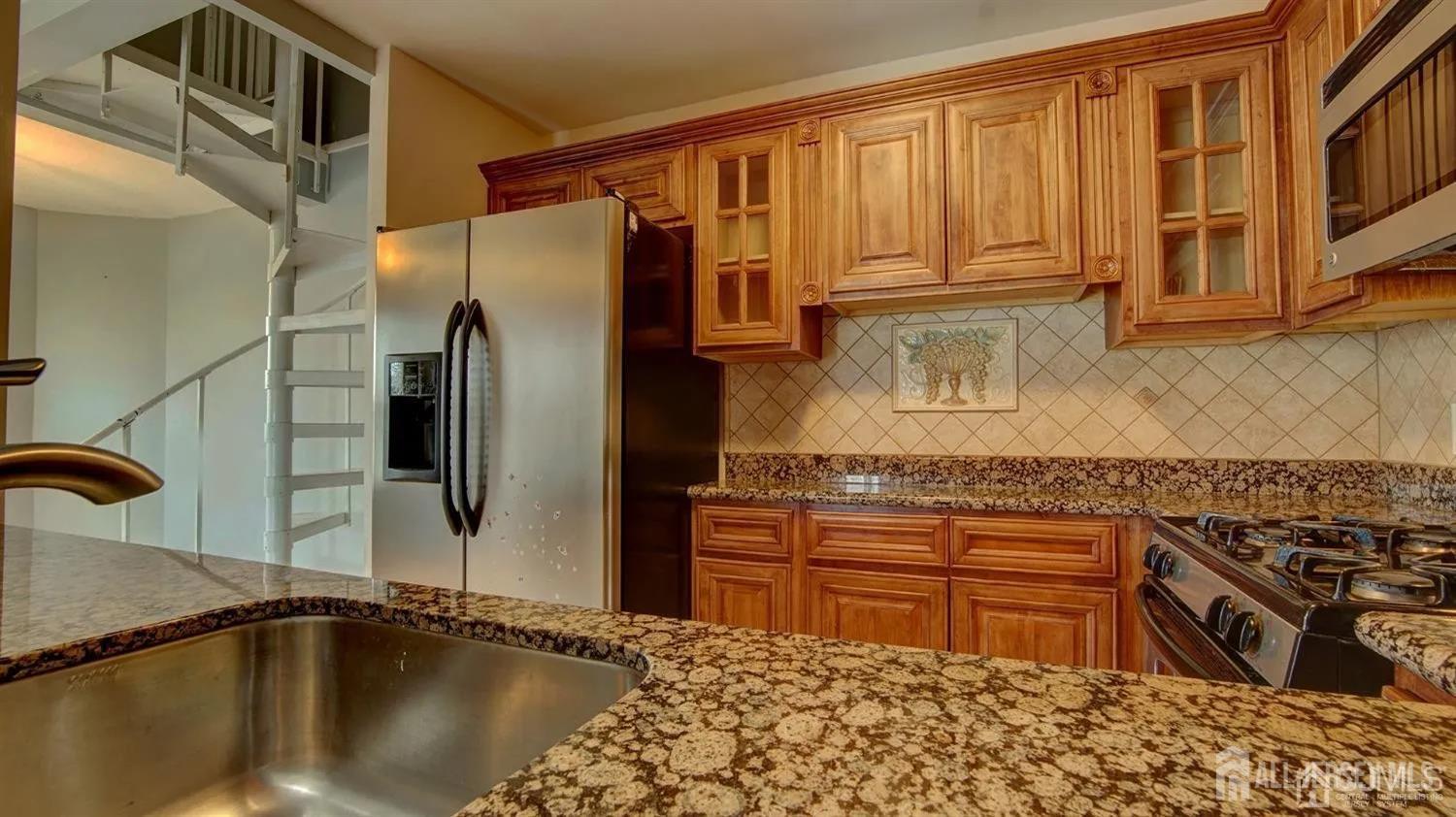 3003 Lighthouse Lane Parlin, NJ 08859 - Photo 9 of 25 a kitchen with stainless steel appliances granite countertop a sink stove and refrigerator