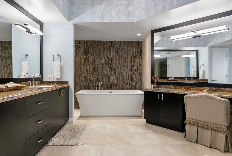 1700 South Ocean Boulevard, Unit 5B Lauderdale-by-the-Sea, FL 33062 - Photo 11 of 47 a bathroom with a granite countertop bathtub sink vanity and mirror