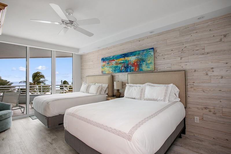 1700 South Ocean Boulevard, Unit 5B Lauderdale-by-the-Sea, FL 33062 - Photo 12 of 47 a bed room with two beds and a large window