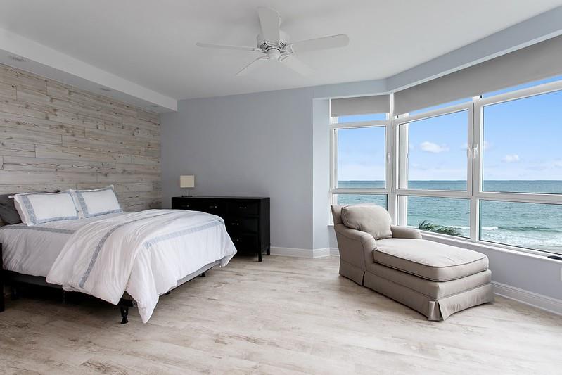1700 South Ocean Boulevard, Unit 5B Lauderdale-by-the-Sea, FL 33062 - Photo 13 of 47 a spacious bedroom with a bed and a couch