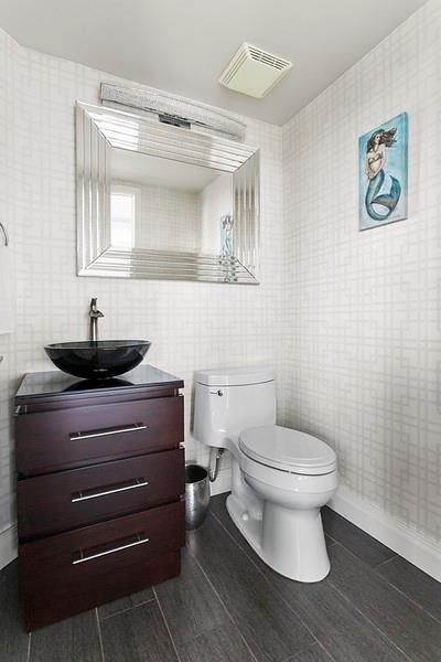 1700 South Ocean Boulevard, Unit 5B Lauderdale-by-the-Sea, FL 33062 - Photo 18 of 47 a bathroom with a toilet a sink and mirror