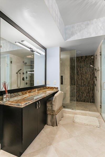 1700 South Ocean Boulevard, Unit 5B Lauderdale-by-the-Sea, FL 33062 - Photo 27 of 47 a spacious bathroom with a granite countertop sink and a mirror