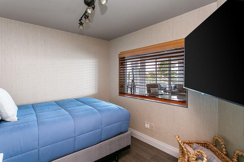 1700 South Ocean Boulevard, Unit 5B Lauderdale-by-the-Sea, FL 33062 - Photo 33 of 47 a bedroom with a bed and a window