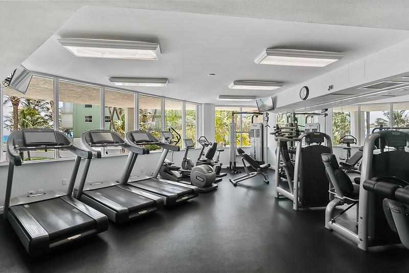 1700 South Ocean Boulevard, Unit 5B Lauderdale-by-the-Sea, FL 33062 - Photo 36 of 47 a room with gym equipment and windows