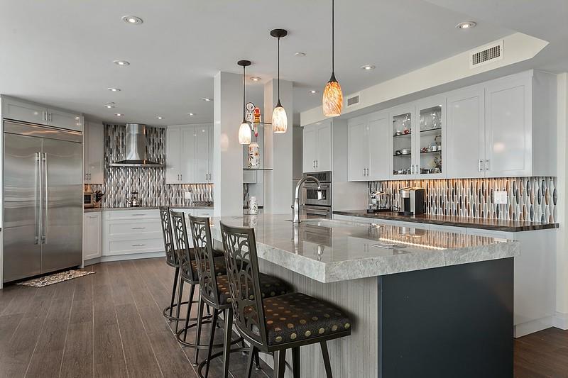 1700 South Ocean Boulevard, Unit 5B Lauderdale-by-the-Sea, FL 33062 - Photo 8 of 47 a kitchen with stainless steel appliances granite countertop a dining table chairs and granite counter tops