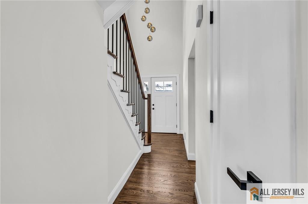 27 Sheppard Place Edison, NJ 08817 - Photo 33 of 75 a view of a hallway with wooden floor and staircase