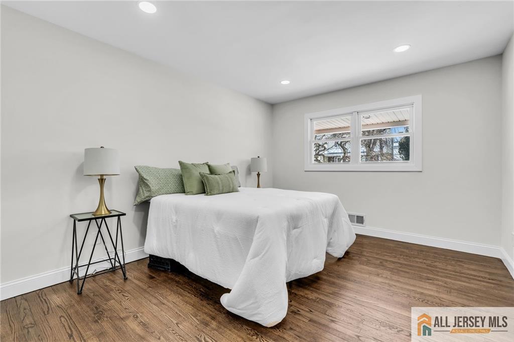 27 Sheppard Place Edison, NJ 08817 - Photo 39 of 75 a bed sitting in a spacious bedroom next to a lamp