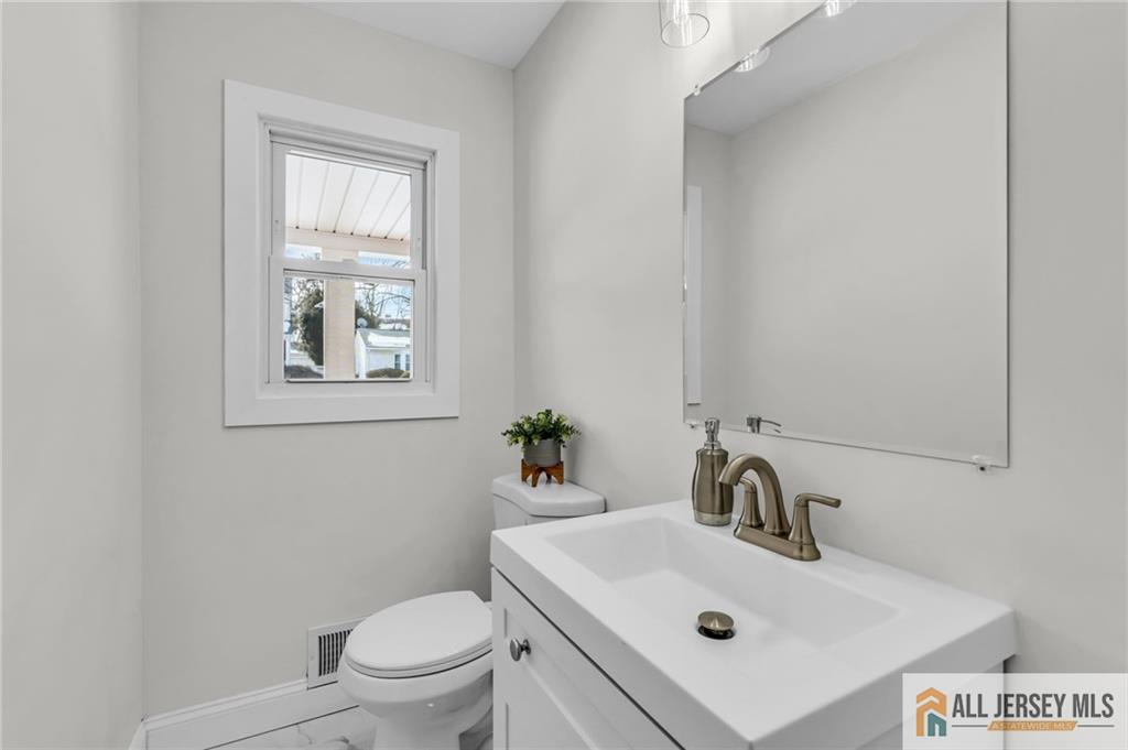 27 Sheppard Place Edison, NJ 08817 - Photo 41 of 75 a bathroom with a sink toilet and a mirror