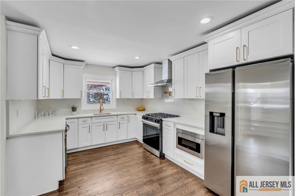 27 Sheppard Place Edison, NJ 08817 - Photo 43 of 75 a kitchen with a refrigerator cabinets and wooden floor