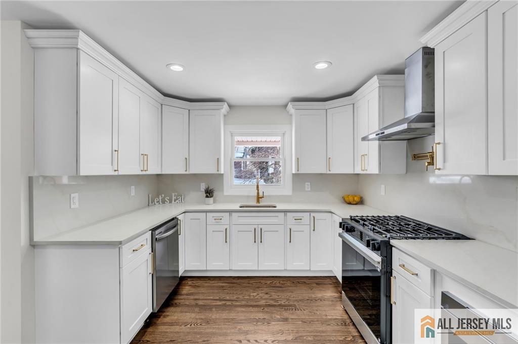27 Sheppard Place Edison, NJ 08817 - Photo 45 of 75 a kitchen that has a lot of white cabinets and stainless steel appliances