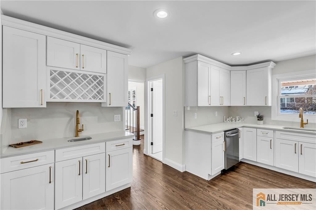 27 Sheppard Place Edison, NJ 08817 - Photo 47 of 75 a kitchen with white cabinets white appliances sink and wooden floor