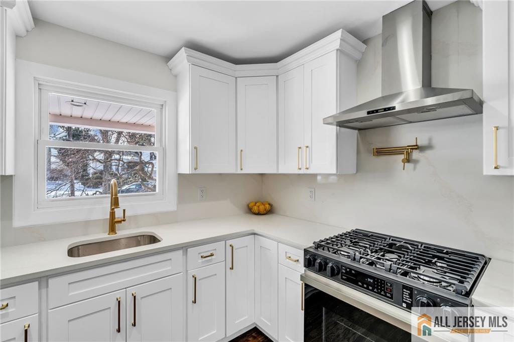 27 Sheppard Place Edison, NJ 08817 - Photo 53 of 75 a kitchen with stainless steel appliances a sink a stove and cabinets