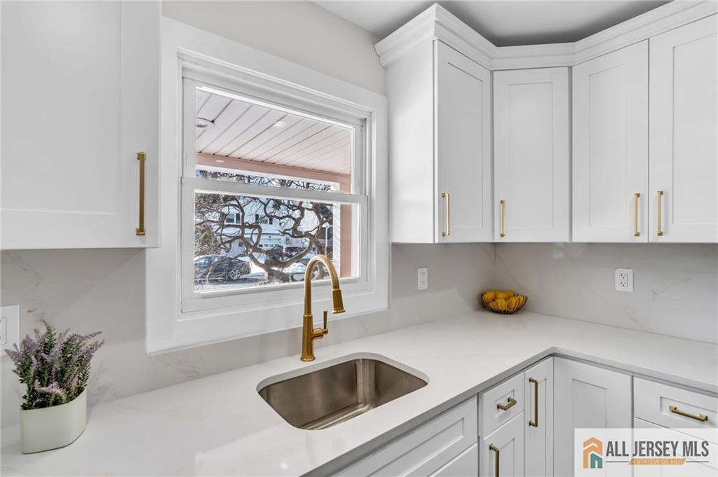 27 Sheppard Place Edison, NJ 08817 - Photo 55 of 75 a kitchen with a sink and cabinets