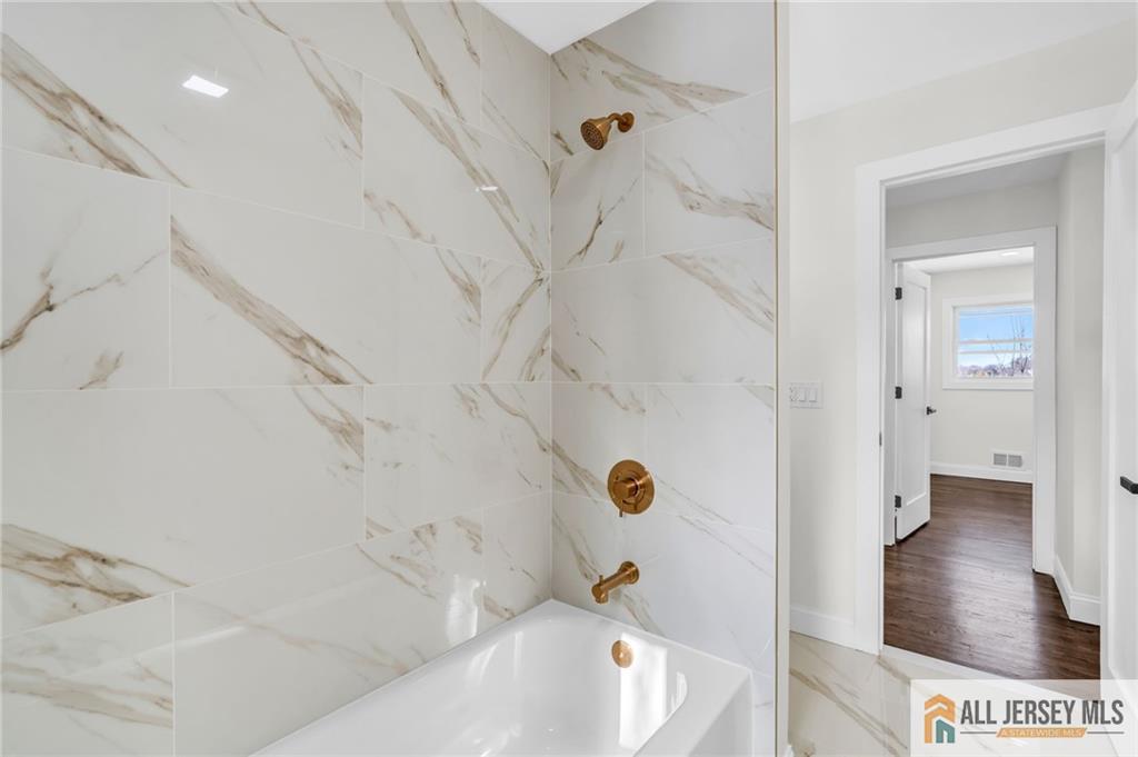 27 Sheppard Place Edison, NJ 08817 - Photo 60 of 75 a bathroom with a bathtub and a shower