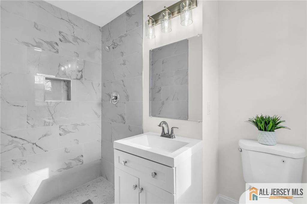 27 Sheppard Place Edison, NJ 08817 - Photo 66 of 75 a bathroom with a sink a toilet and shower