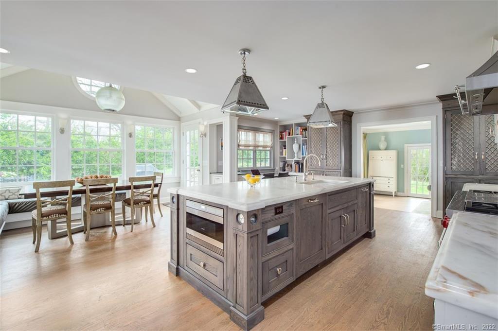 a kitchen with kitchen island granite countertop a large center island and a table in it