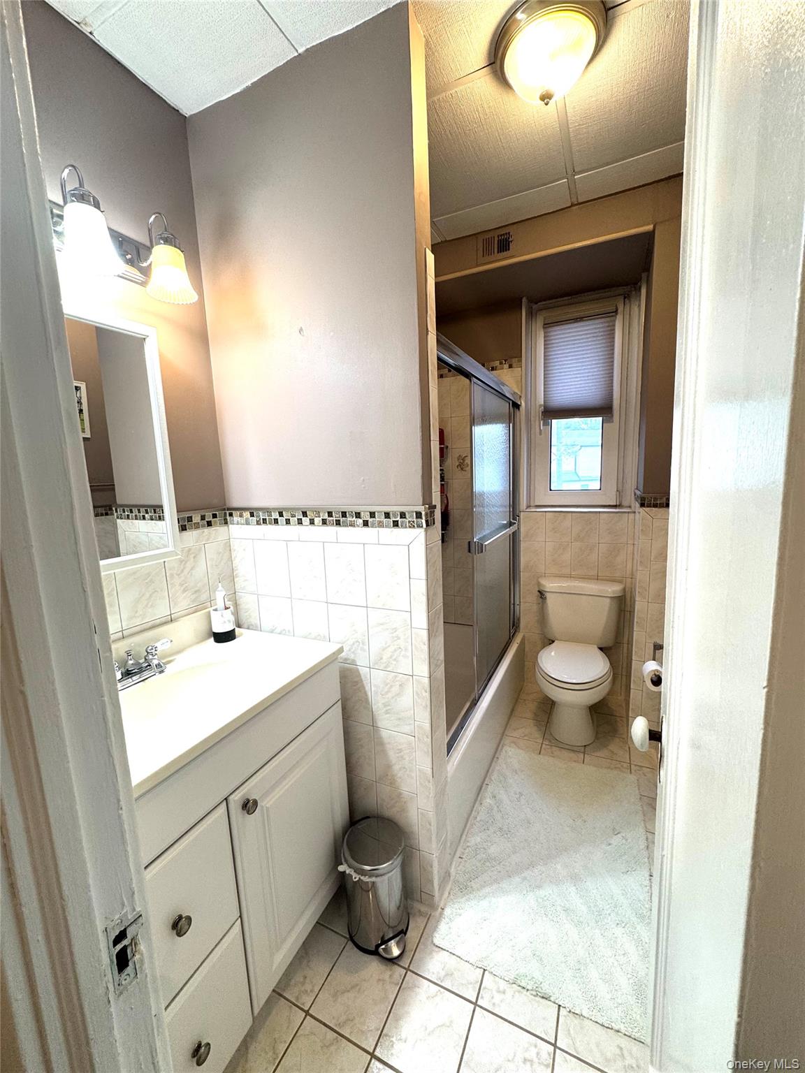 69 Harney Road, Unit 5B Scarsdale, NY 10583 - Photo 11 of 17 a spacious bathroom with a sink a toilet and mirror