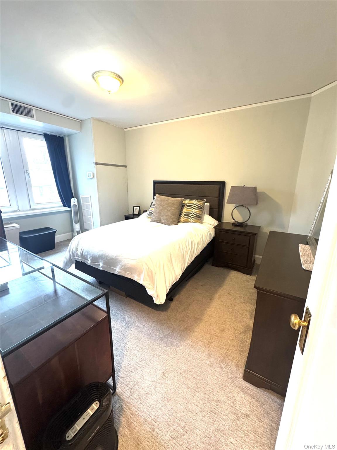 69 Harney Road, Unit 5B Scarsdale, NY 10583 - Photo 12 of 17 a bedroom with a bed and a night stand