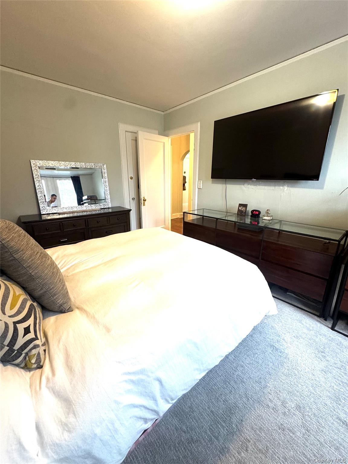 69 Harney Road, Unit 5B Scarsdale, NY 10583 - Photo 14 of 17 a bedroom with a bed and a flat screen tv