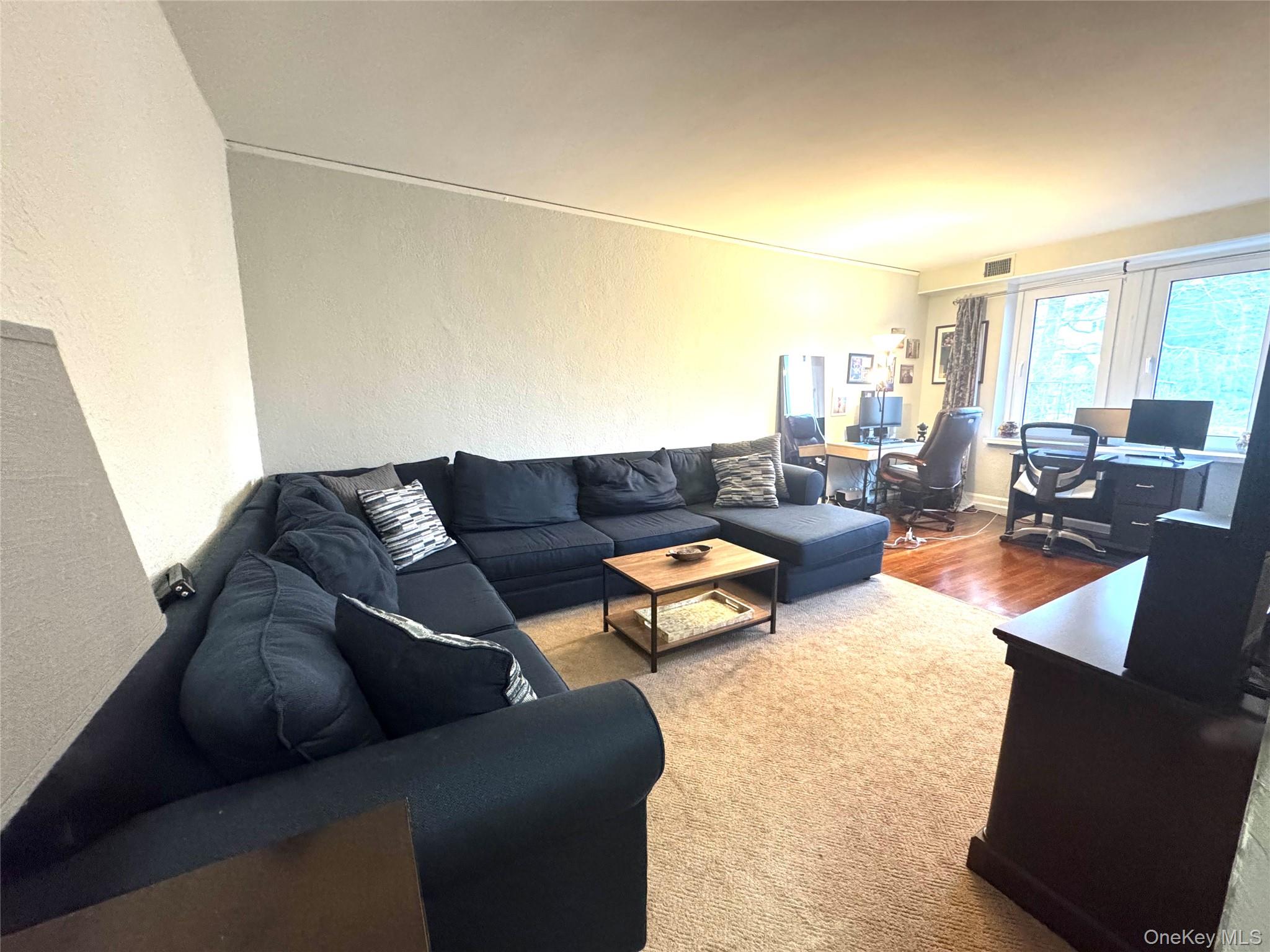 69 Harney Road, Unit 5B Scarsdale, NY 10583 - Photo 15 of 17 a living room with furniture and a large window