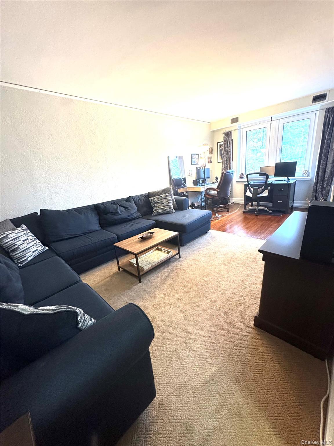 69 Harney Road, Unit 5B Scarsdale, NY 10583 - Photo 16 of 17 a living room with furniture and a couch