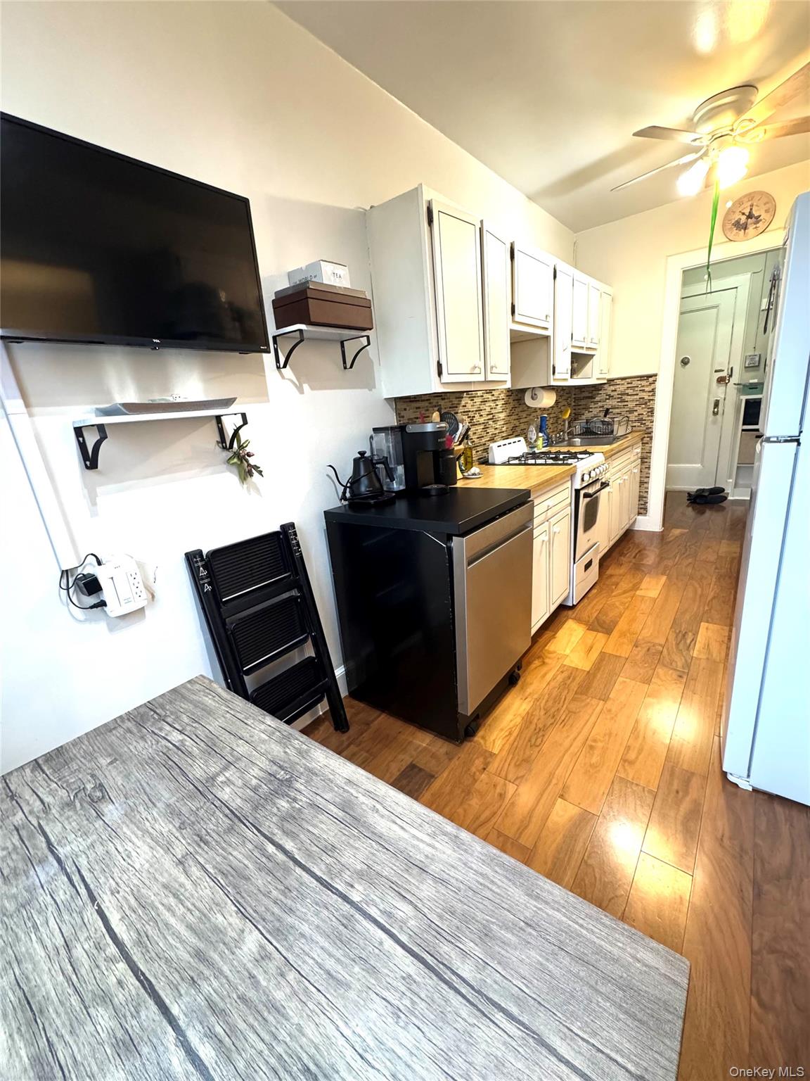 69 Harney Road, Unit 5B Scarsdale, NY 10583 - Photo 9 of 17 a kitchen with a sink appliances and cabinets