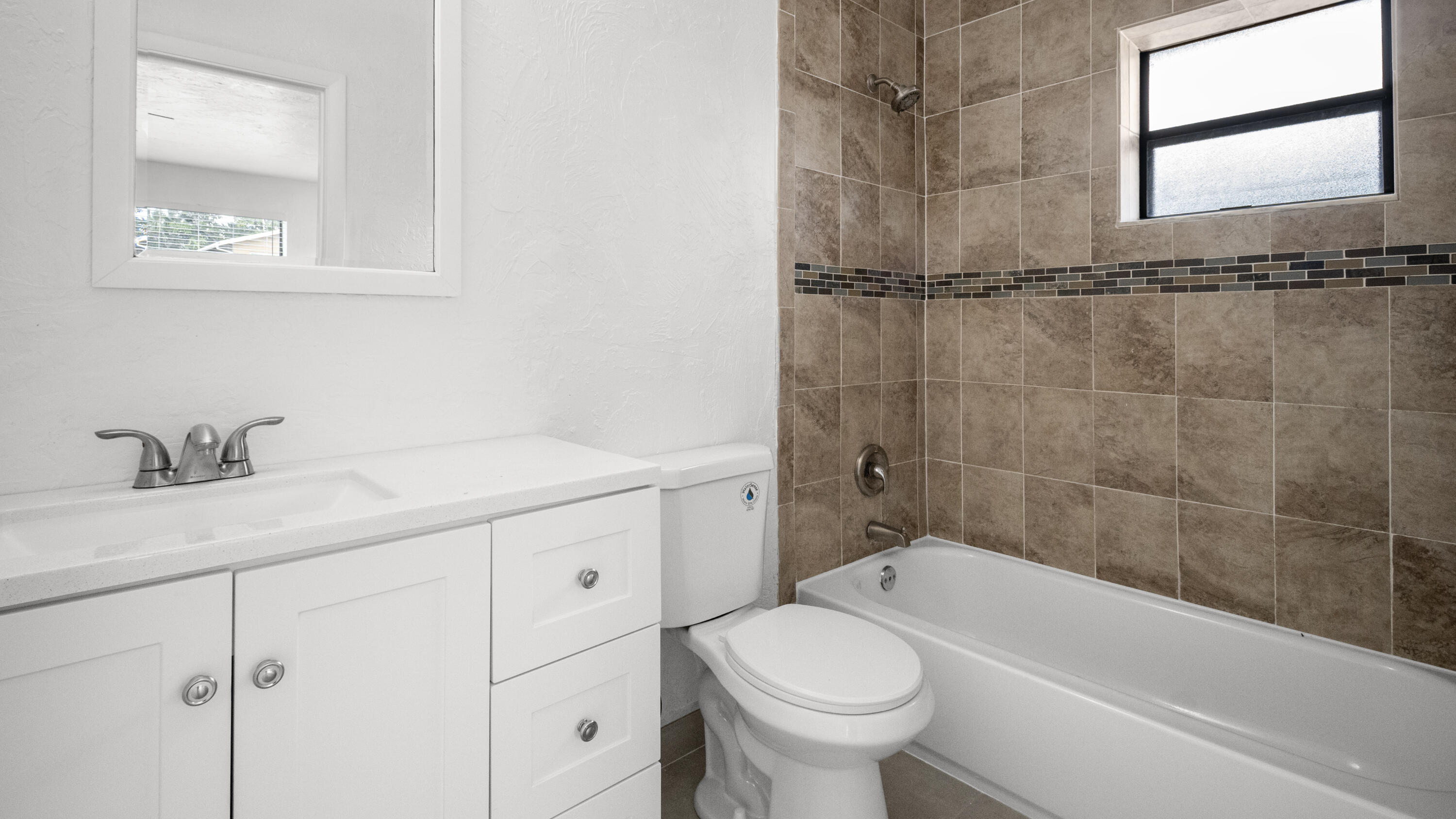 1233 West 32nd Street Riviera Beach, FL 33404 - Photo 18 of 25 a bathroom with a granite countertop sink a toilet and shower