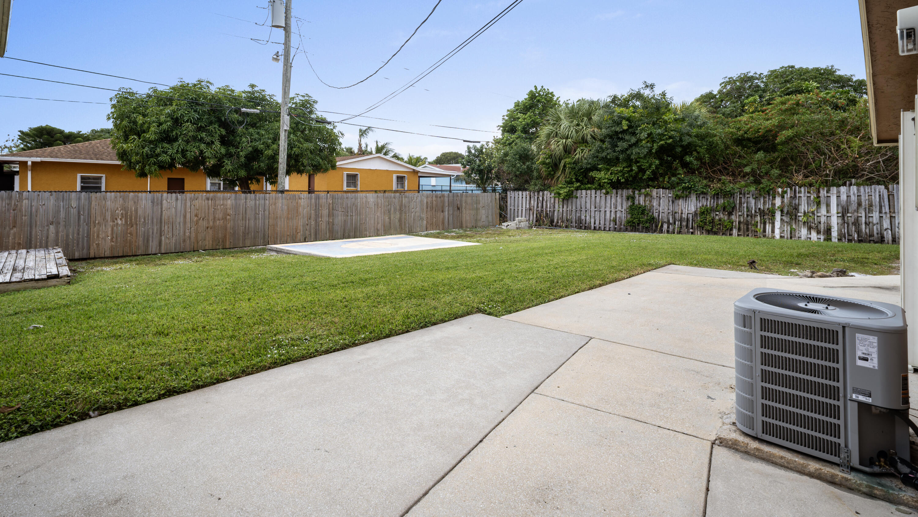 1233 West 32nd Street Riviera Beach, FL 33404 - Photo 23 of 25 a view of a backyard with wooden fence