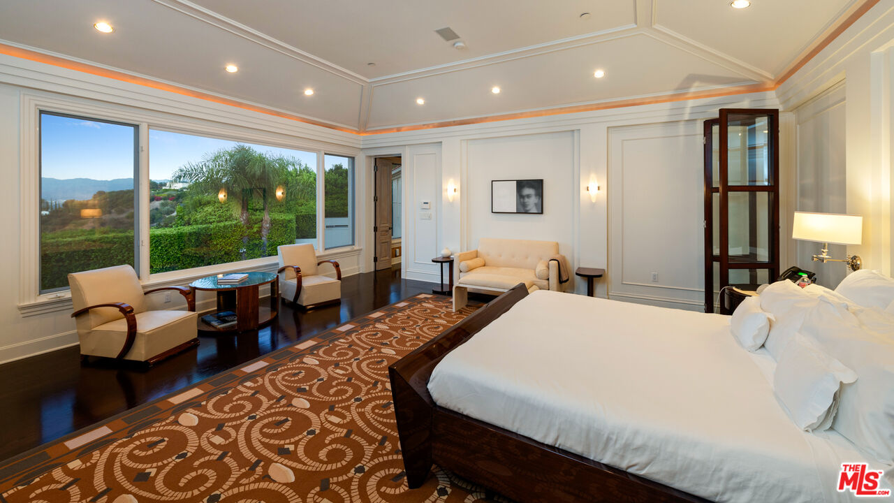 14035 Aubrey Road Beverly Hills, CA 90210 - Photo 16 of 24 a large bedroom with bed and large windows