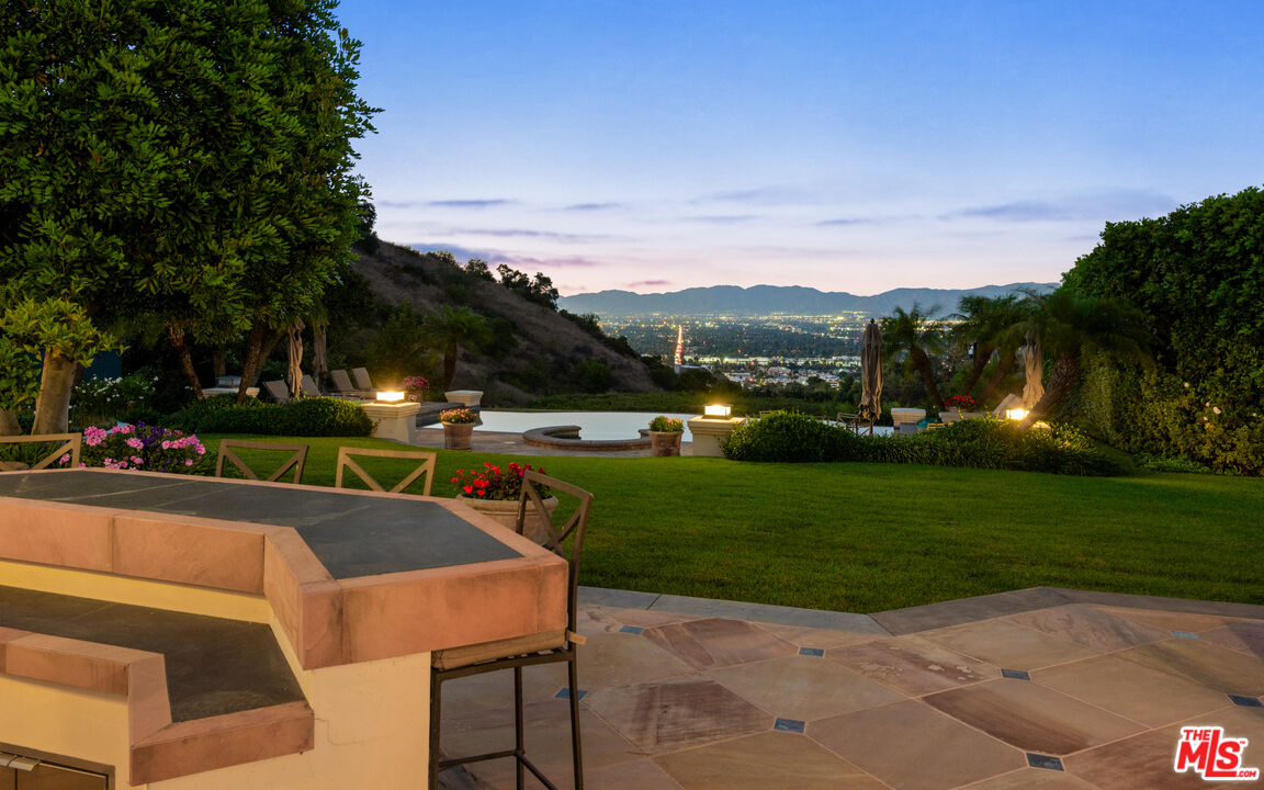 14035 Aubrey Road Beverly Hills, CA 90210 - Photo 23 of 24 a view of a table and chairs in the garden