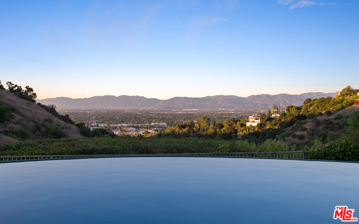 14035 Aubrey Road Beverly Hills, CA 90210 - Photo 24 of 24 a view of a lush green field with a tree in the background
