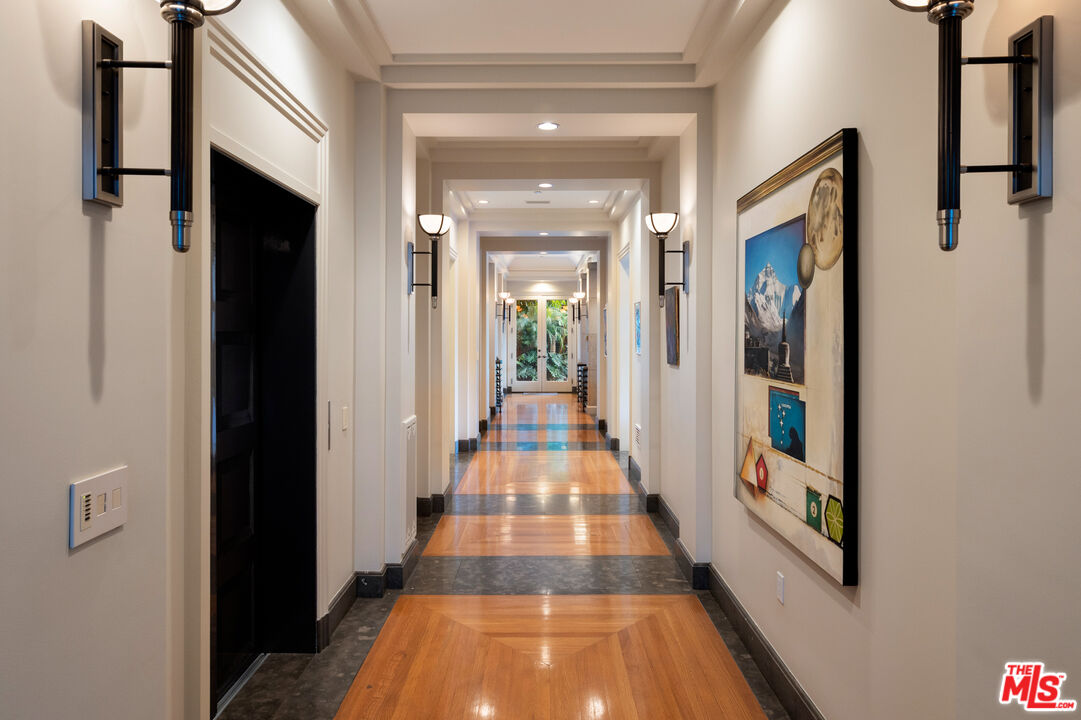 14035 Aubrey Road Beverly Hills, CA 90210 - Photo 6 of 24 a view of a hallway with wooden floor and staircase